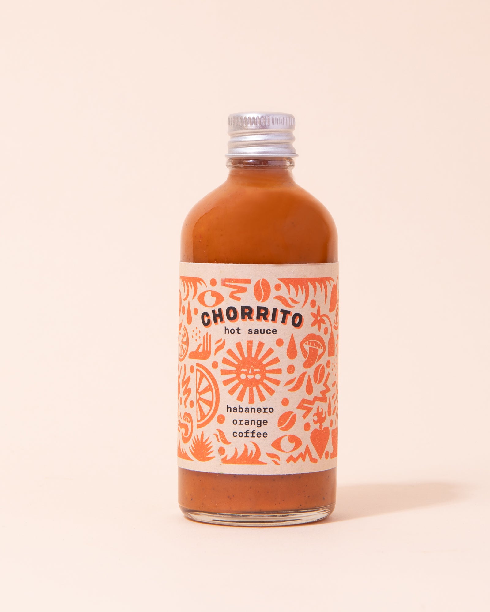 Orange habanero, orange and coffee hot sauce in a glass bottle