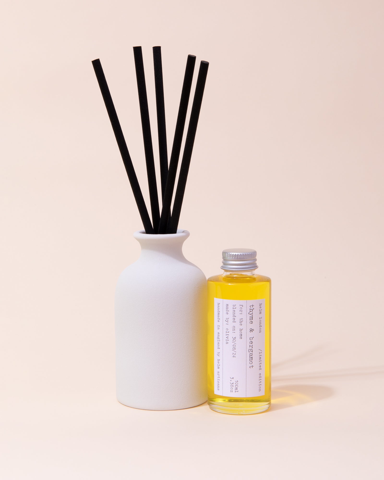 White ceramic diffuser with black reeds and thyme & bergamot fragrance