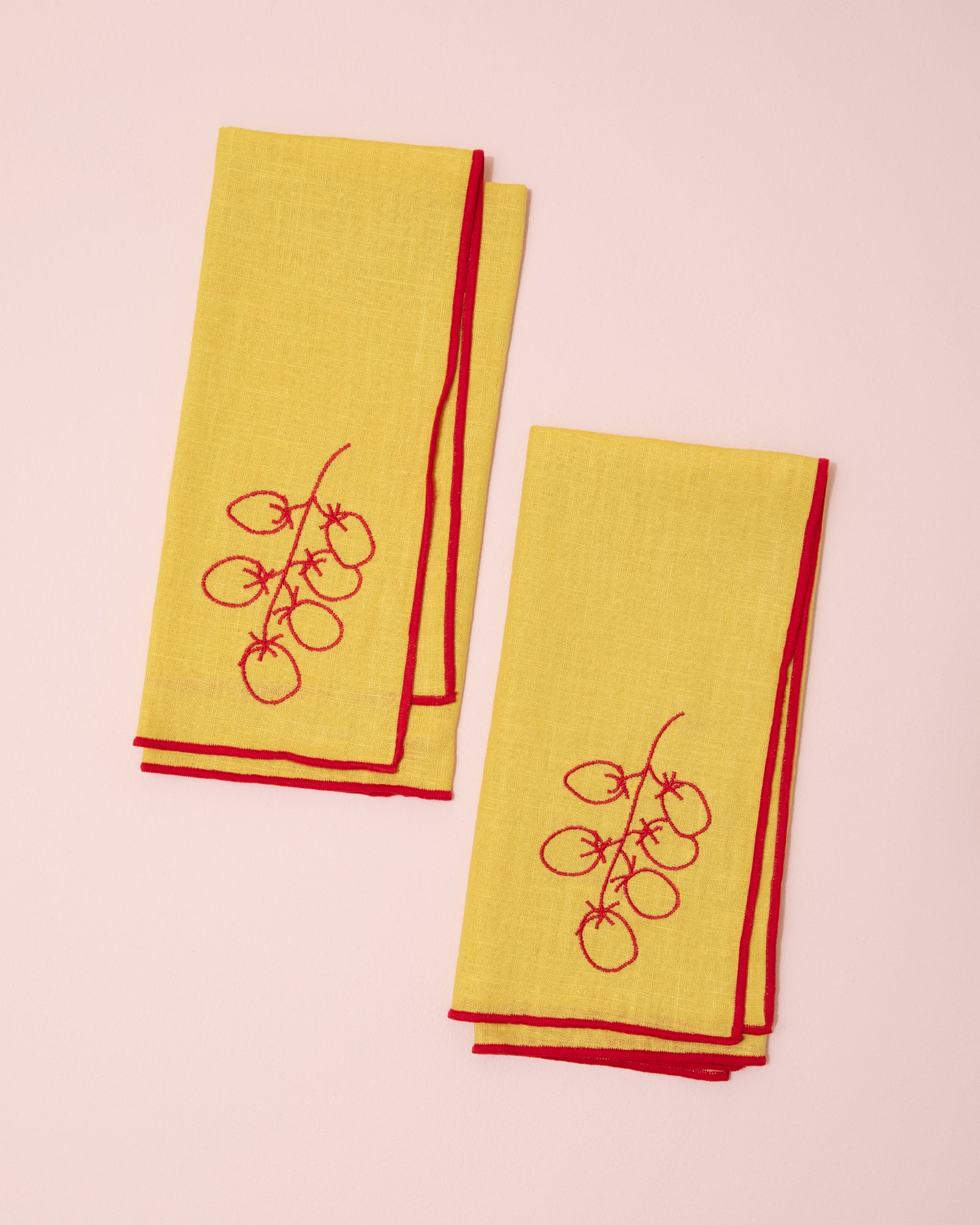 Red and yellow embroidered linen napkins with tomato design