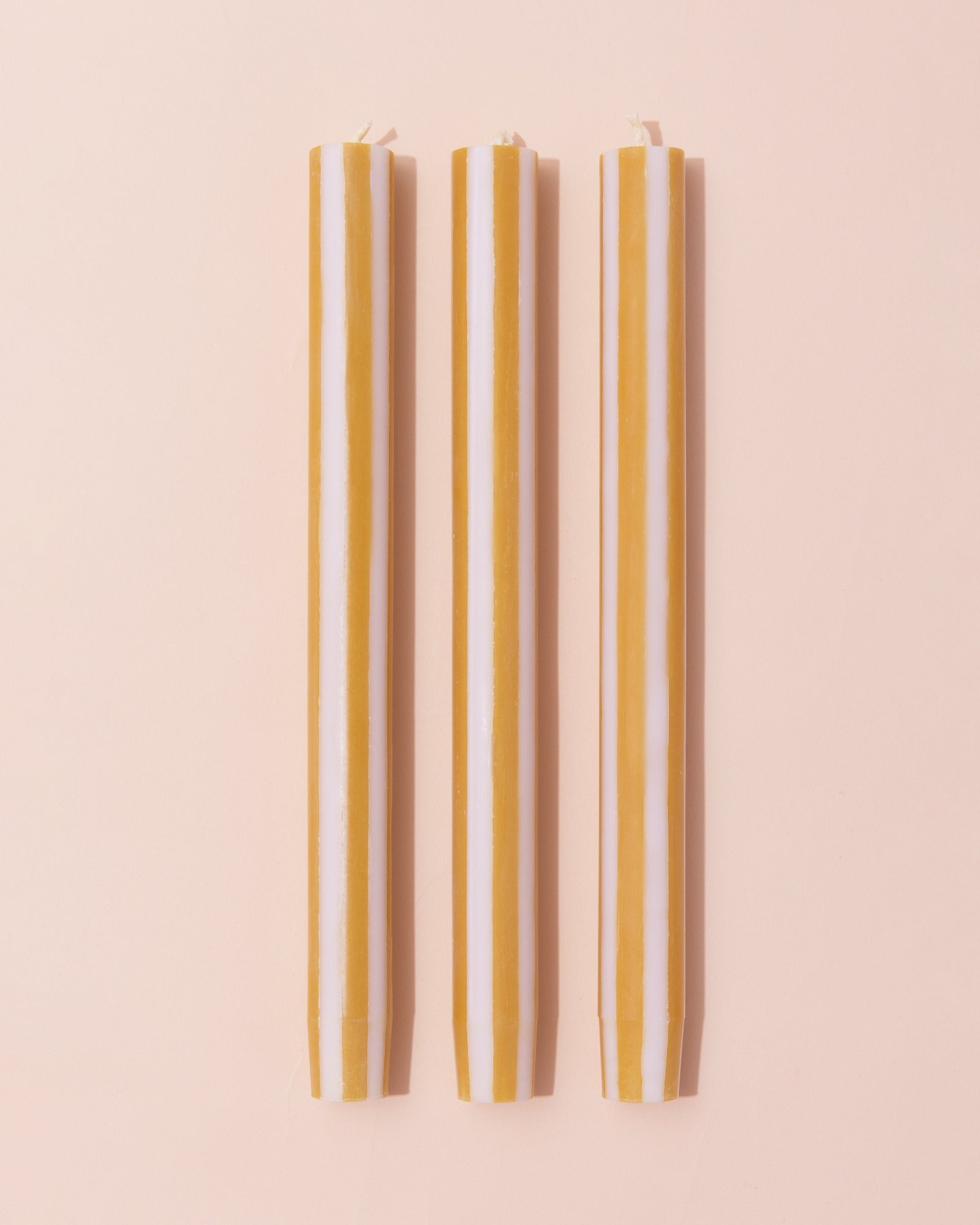 Yellow and white striped dinner candle