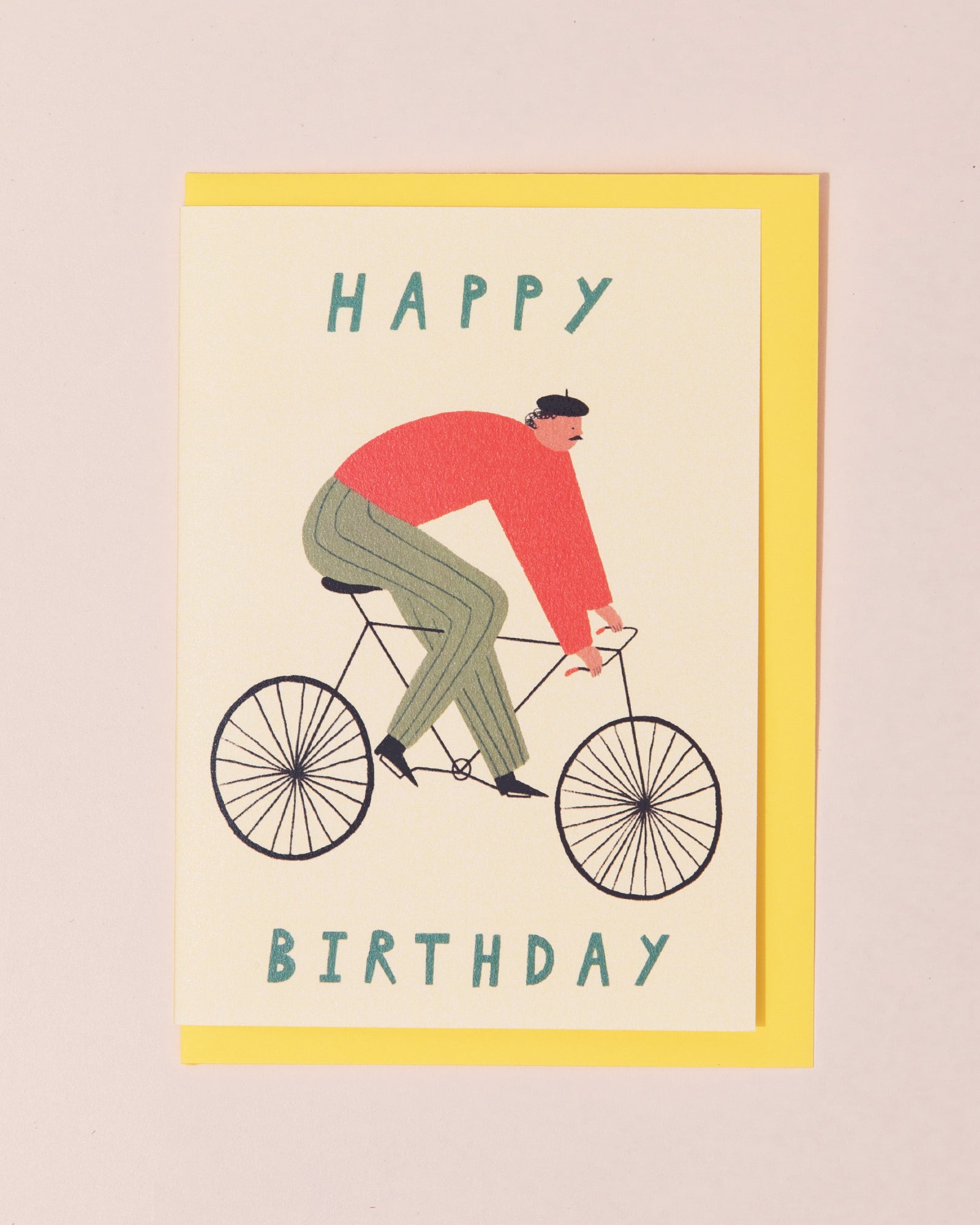 Birthday greetings card with a man wearing a beret riding a bike