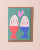 Greetings card with illustration of eggs with smiling faces and a heart