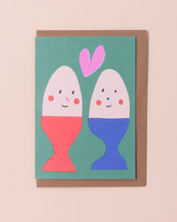 Greetings card with illustration of eggs with smiling faces and a heart