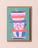 Greetings card with colourful illustration of tea cups with smiling faces