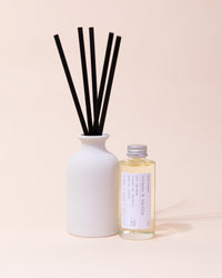 White ceramic diffuser with black reeds and tobacco & vanilla fragrance
