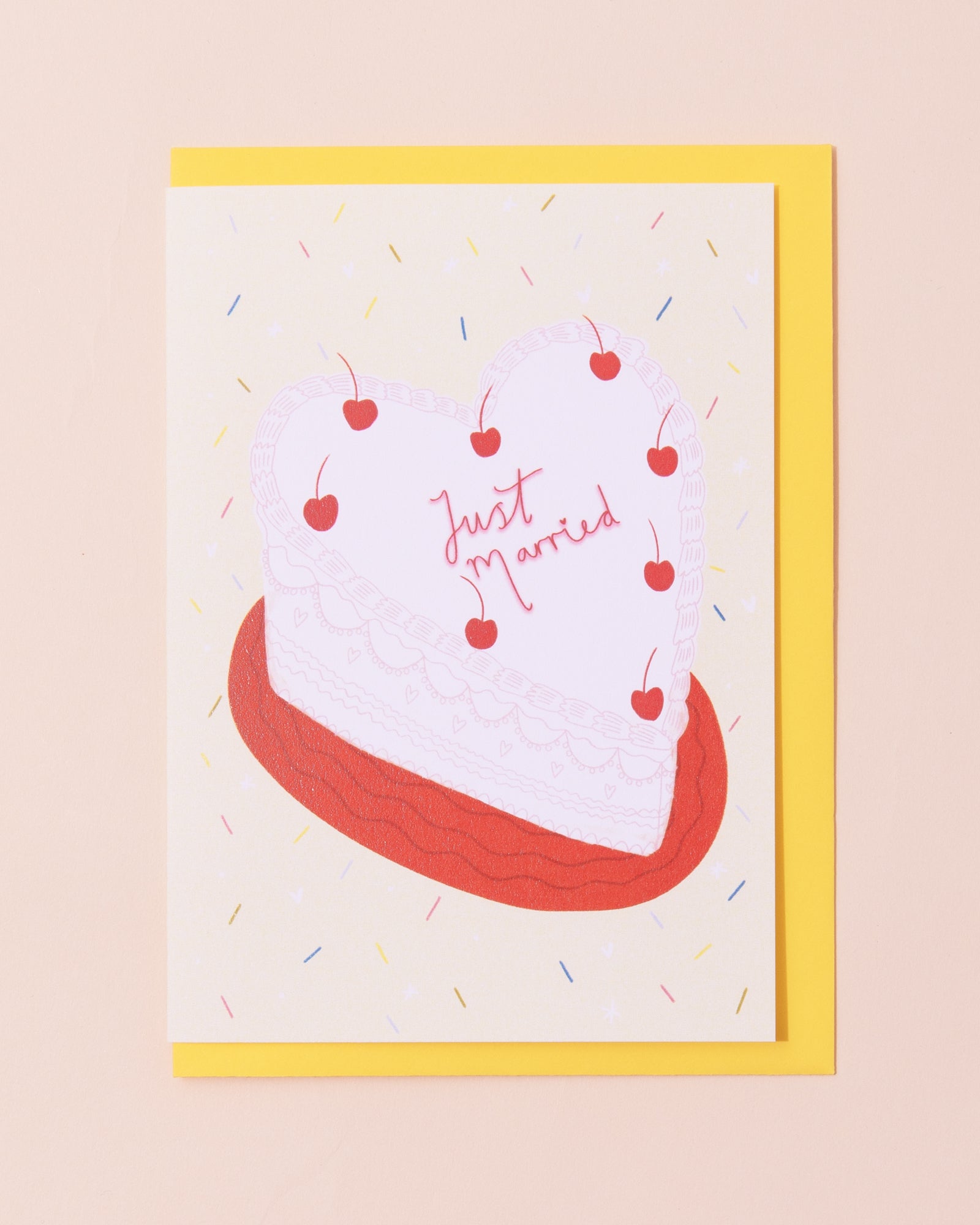 Colourful greetings card with a cake frosted with 'Just Married'