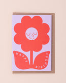 Birthday greetings card with a red smiling flower