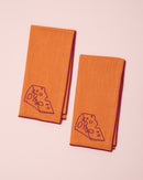 Orange and burgundy embroidered linen napkins with cheese design