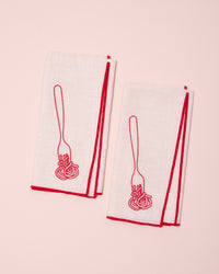 White and red linen napkins with embroidered fork and spaghetti design
