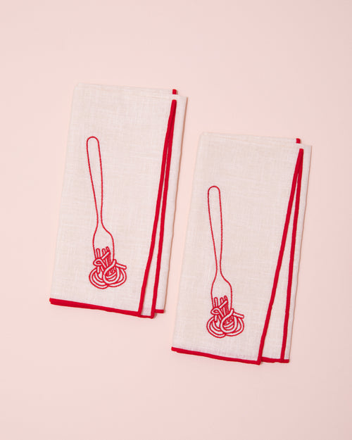 White and red linen napkins with embroidered fork and spaghetti design
