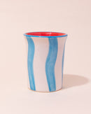 Ceramic tumbler with blue and white wavy stripes